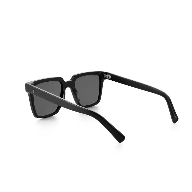 Black square-framed sunglasses angled on a white background.